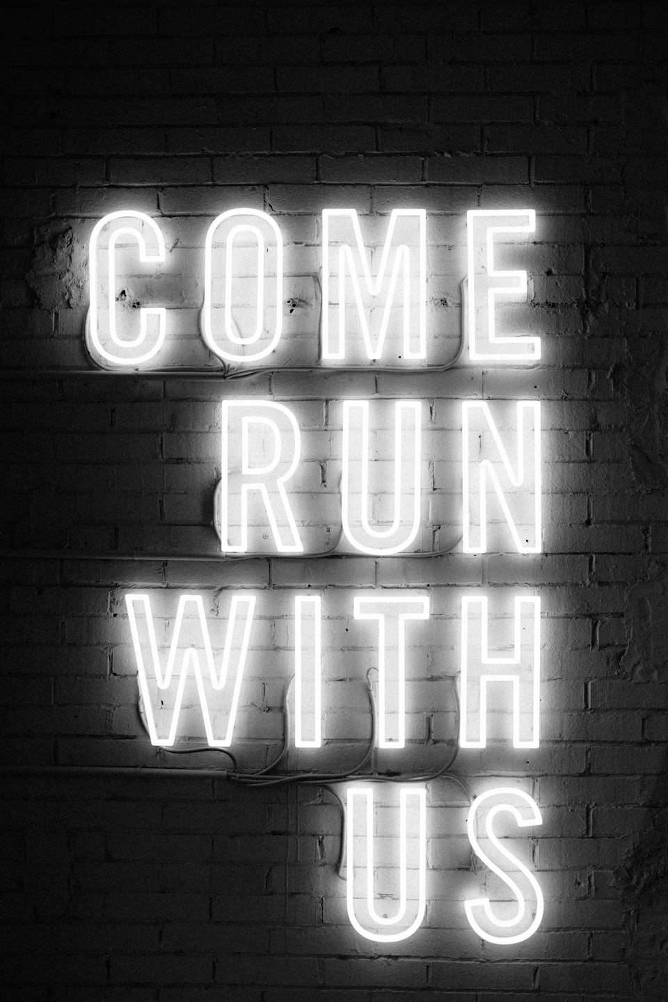 Come Run With Us white neon sign